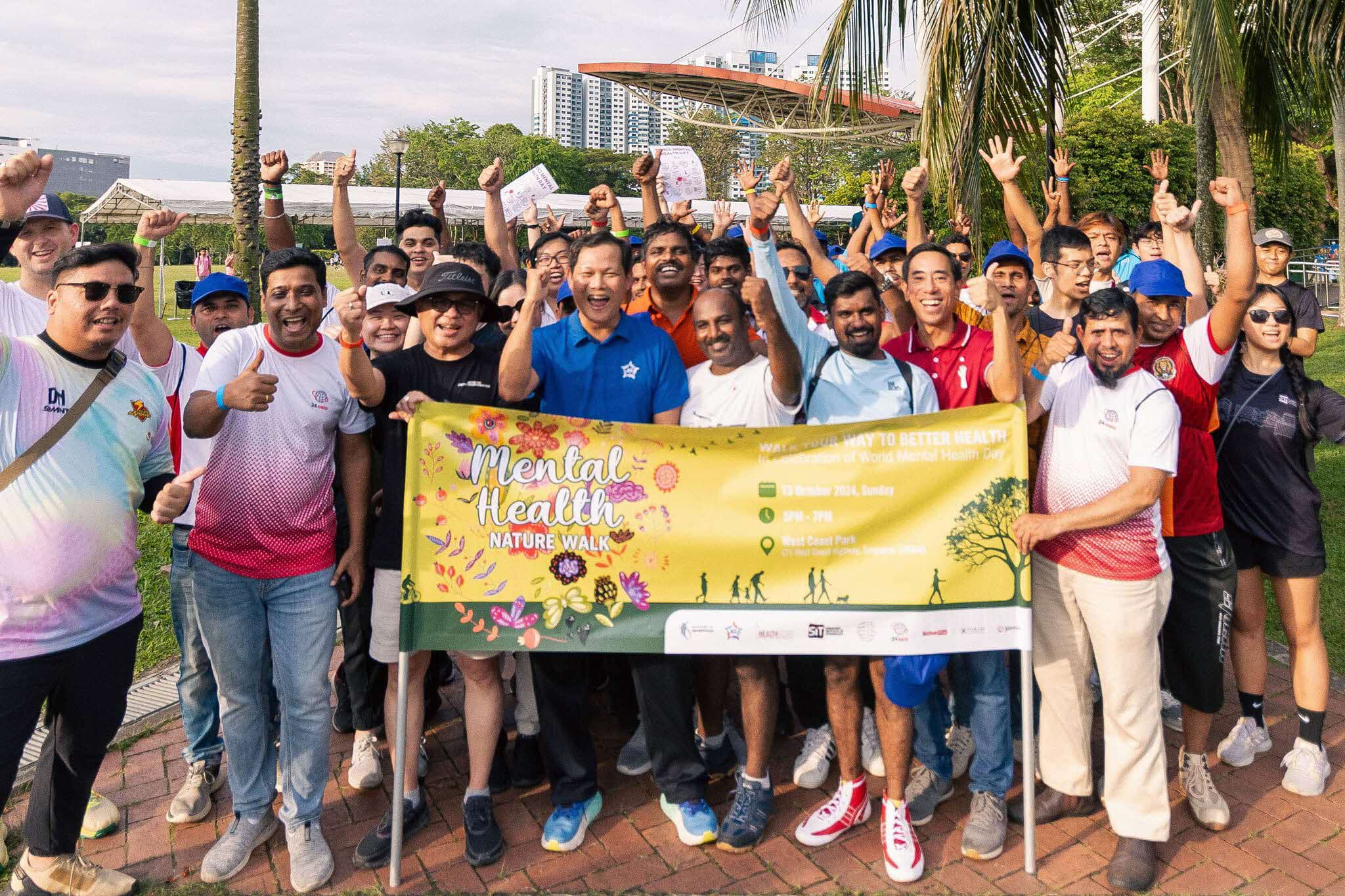 Image shows a group of people holding a banner.