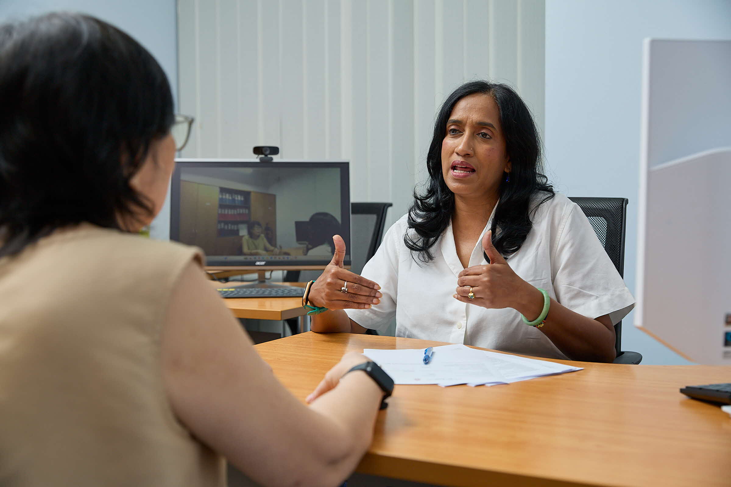 Photo of the consultant speaking with the potential employer