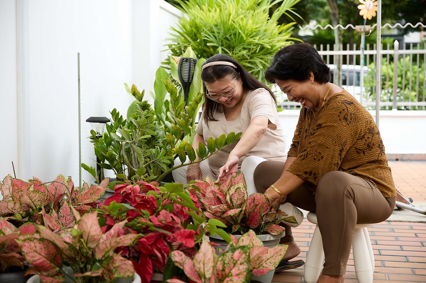 Coreen and Darsiti caring for plants